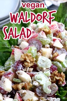 a salad with apples, grapes and walnuts in it on top of lettuce