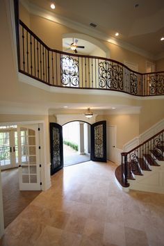 a large open floor plan with stairs and railings