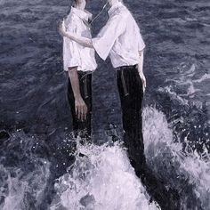 two people standing in the water with their arms around each other