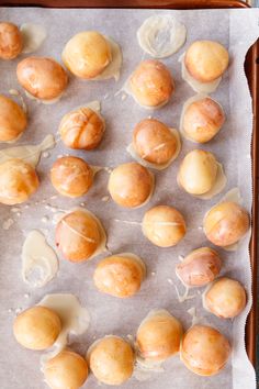 there are many different types of doughnuts on the baking sheet with icing