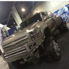 a silver truck is on display in a showroom