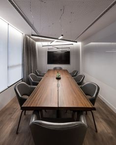 a long wooden table with chairs around it