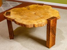 a wooden table sitting on top of a carpeted floor