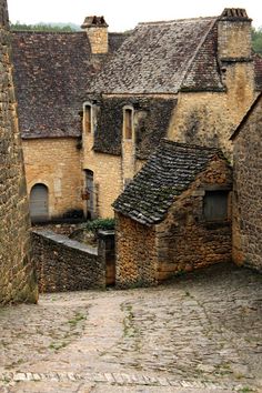 an old cobblestone street with stone buildings