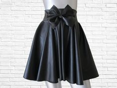 This is a modern and funky twist on your traditional skater skirt. The high waist, center front bow and faux leather gives it that high fashion edge we all love and adore! The bow skater skirt can easily be dressed up or dressed down. Available in sizes XS - 4XL PLEASE view size chart provided before ordering From waist (not top of waistband) to hem this skirt measures 17 inches long ( can be lengthened by request for an additional fee) Ther are no returns accepted for my custom-made items, even exchange or merchandise credit only! In order to receive an even exchange or merchandise credit the item must be returned unworn with all tags attached. The item must be free of any soilage, stains, perfume smells or any other odors. Trendy Pleated Mini Skirt For Party, Fitted Trendy Skirt For Evening, Trendy Fitted Skirt For Evening, Trendy Fitted Evening Skirt, Party Pleated Mini Skirt, Pleated Mini Skirt For Party, Trendy Pleated Party Skirt, Pleated Fitted Skort For Party, Chic Party Skort With Flowy Skirt