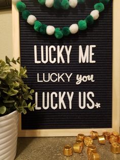 a sign that says lucky me lucky you lucky us with gold and green decorations around it