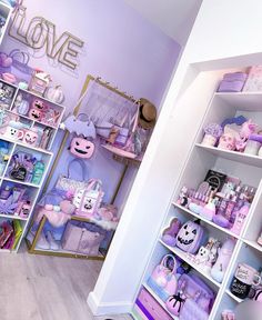 a room filled with lots of purple and white items on shelves next to each other