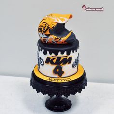 a three tiered cake with yellow and black decorations