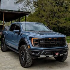 a blue truck parked in front of a building