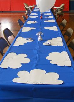 a blue table with white clouds on it and a balloon in the air at the top