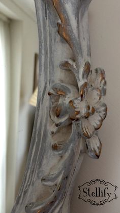 an ornate mirror hanging on the wall next to a window