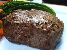 a close up of a plate of food with meat and veggies on it