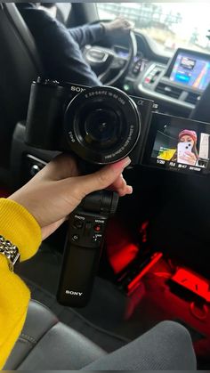 a person holding up a camera in their hand