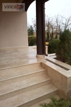 an outdoor patio with steps leading up to it