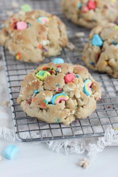 cookies with sprinkles and colored candies on a cooling rack