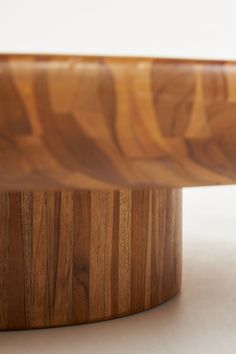 a close up of a wooden bowl on a white surface