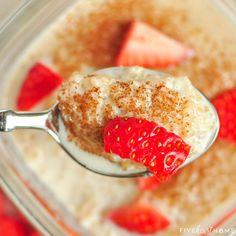 a spoon full of pudding with strawberries on top