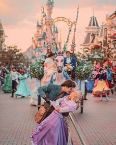 a man kissing a woman on the cheek at disneyland