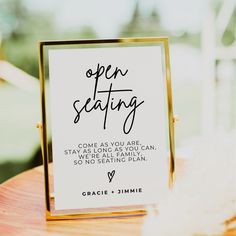 an open seating sign sitting on top of a wooden table