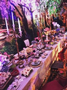 a long table covered in plates and flowers