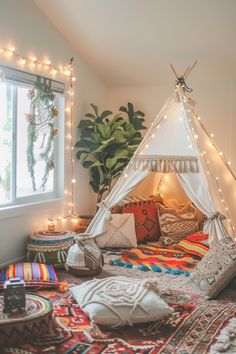 a teepee with lights and pillows on it