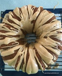 a bundt cake with icing sitting on top of a cooling rack