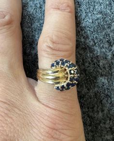 Thank you for viewing Wrenn Estate  Classic retro style sapphire ring that will be a fantastic addition to your jewelry collection.  18 round brilliant cut blue sapphires are set into 14k yellow gold in a retro style 1980s ring.  Size 6 1/4 4.7 grams yellow gold  18 sapphires Hallmarked "14k BH" Vintage 14k Gold Sapphire Ring With Prong Setting, Art Deco Multi-stone Sapphire Ring, Vintage Sapphire Ring In 14k Gold With Prong Setting, Vintage Round Sapphire Diamond Ring, 14k Gold Art Deco Sapphire Ring, Art Deco Gold Sapphire Ring In 14k Gold, Vintage Hallmarked Sapphire Ring With Round Cut, Gold Art Deco Sapphire Ring In 14k Gold, Art Deco 14k Gold Sapphire Ring