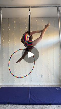 a woman doing aerial acrobatics on a hoop