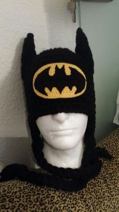 a knitted batman hat on top of a mannequin head