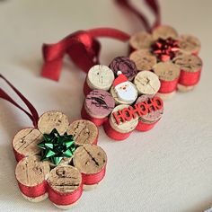 three wine cork ornaments with red ribbon and bows