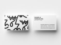 the business card is designed to look like an abstract painting with black and white lines