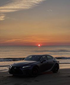 a car parked on the beach at sunset