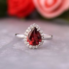 Presenting You A Beautiful Cluster Garnet Ring that you can Stack along with other Ring or go the way you like Combo. The Garnet is All Natural And Eye Clean Accented along with Cubic Zircon to add more sparkle. Perfect For Proposal Wedding Gift or Anniversary Present or Being Garnet Jan birthstone you can gift it on Birthdays too. The Lustre Refraction Along with Rich Red  Color of the Gem is definitely the query maker. Item No: skj. 09.484 Item: Natural Garnet In 925 Silver (Can Be personalized) Primary Stone: Natural garnet  Secondary Stone: Cubic Zircon Article Weight:2.3 gms primary stone Size:7x9 mm Ring Length:2cm Ring Width:1.1  cm Maintenance Tips 1. Keep the jewelry away from direct heat, water, perfumes, deodorants, and other strong chemicals.  2. Wipe the Jewellery gently with Silver Halo Teardrop Rings, Silver Teardrop Halo Rings, Fine Jewelry Teardrop Crystal Ring For Anniversary, Teardrop Crystal Ring For Anniversary, Teardrop Halo Ring For Anniversary, Teardrop Gemstone Ring For Proposal, Silver Teardrop Jewelry For Proposal, Gift Pear-shaped Halo Diamond Ring, Gift Pear-shaped Diamond Ring With Halo