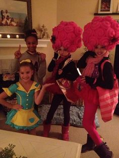 four children dressed up in costumes posing for the camera