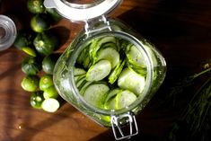 pickles in a glass jar on a wooden table