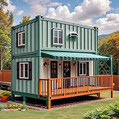 a house made out of shipping containers with a deck on the front and second floor