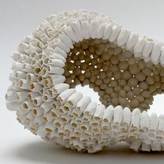 a sculpture made out of white objects on a white surface with no one around it