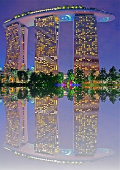 the reflection of two tall buildings in water