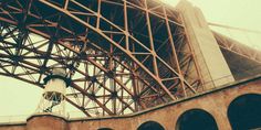 an old photo of the underside of a bridge