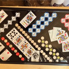 a table topped with lots of playing cards and dice