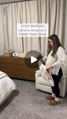 a pregnant woman sitting on a chair in front of a bed with the caption cozy bedside nursery setup as a third time mom