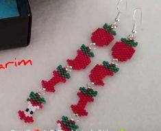 the beaded earrings are decorated with red and green beads, which look like apples