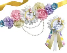 two ribbons with flowers and pearls on them