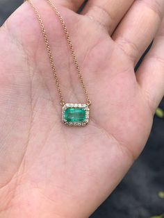 Featured here is a stunning East to West Colombian emerald and diamond halo necklace made in fine 14K yellow gold. Displayed is a lustrous, medium-light green with incredible transparency, accented by a simple four-prong 14K mount, allowing for the emerald to be shown in full view. Brilliant round diamonds halo around the emerald. The chain is stationary and is 18 inches long. This piece is ideal for everyday wear or for special occasions. Setting Style: Prong/ Pave Setting Material: 14K Yellow Emerald Cut Green Jewelry With Pave Setting, Fine Jewelry With Emerald Cut And Pave Setting, Fine Jewelry Emerald Cut Necklace With Halo Setting, Emerald Jewelry With Pave Setting, Diamond Jewelry With Pave Setting For May Birthstone, 14k Gold Green Jewelry With Pave Setting, Emerald Cut Halo Setting Fine Jewelry Necklaces, Green 14k Gold Jewelry With Pave Setting, Emerald Cut Halo Setting Fine Jewelry Necklace