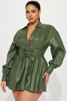 a woman wearing a green leather shirt dress