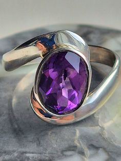 Sterling silver 925 ring - amethyst faceted (really shiny)  oval stone with simple wrap around setting - stunning ring - very comfortable and light to wear, and combine well with other jewellery.   AAA quality silver and crystals.    This ring comes gift wrapped and would make an ideal birthday gift, Valentine's Day Gift, Mother's Day Gift, anniversary gift or for any occasion. Amethyst is said to be the bridge that connects the concrete with the divine - the meaning of Amethyst has long been sy Pisces Birthstone, Oval Amethyst Ring, Ring Purple, Purple Amethyst Ring, Aquarius Pisces, Purple Crystal, 925 Ring, February Birthstone, Oval Stone