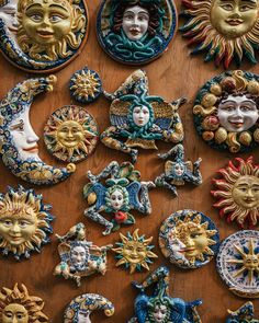 many decorative sun and moon cookies on a wooden table with the faces of different people