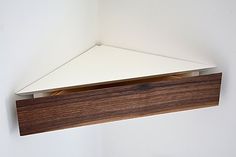 a wooden shelf mounted to the side of a wall