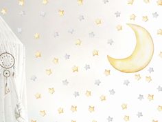 a child's room with stars and a crescent wall decal on the wall