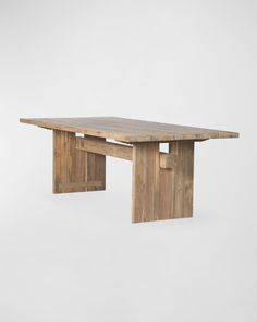 a wooden table sitting on top of a white wall